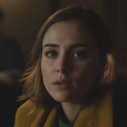 a woman sitting down next to a man