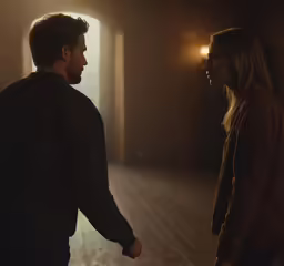 a man and a woman standing in an empty room