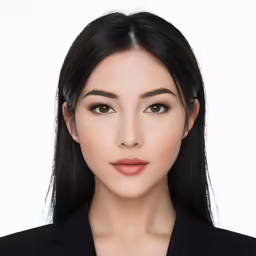 a woman in a suit looks into the camera