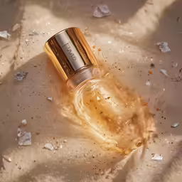 a bottle of joligrace sits in the sand