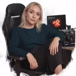 a girl is sitting in a chair next to a camera