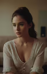 a woman in a white dress staring away from the camera