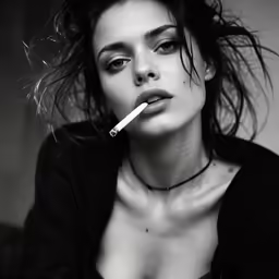 a very beautiful woman with a cigarette in her mouth
