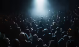 a crowd of people is gathered at a theater