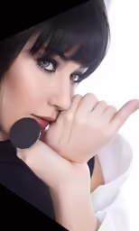 a woman is posing with her hand up against her neck