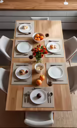 a table with fruit and plates on it is arranged