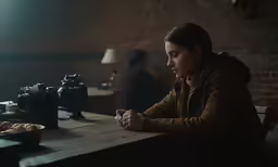 a woman sitting at a table with food in front of her