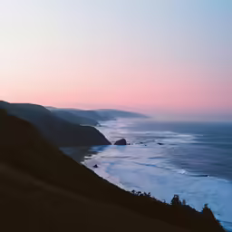 a view of the coast of a beach with a hazy sky