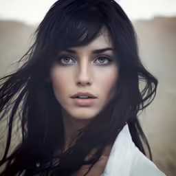 a woman with long black hair with long lashes and blue eyes