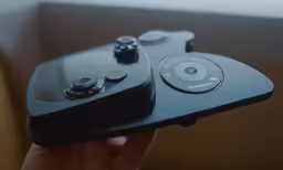 a closeup of a black video game controller