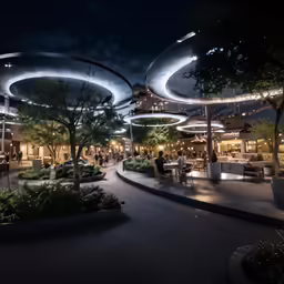 many tables and chairs in a very long circle with lights