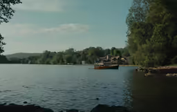 a small wooden boat is out on the water