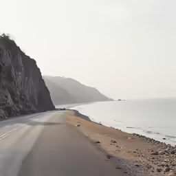a truck on the side of the road by some mountains