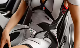 a woman with a futuristic bodysuit and leather knee boots