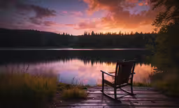 a bench that is on some wooden platform,a chair sitting on a pier overlooking a lake at sunset