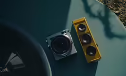 there is a camera next to a yellow box