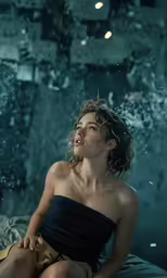a woman in a black top is under a shower of rain
