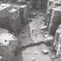 some people standing in a cave next to the rocks