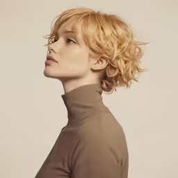 a blonde woman with short hair and bangs is looking up