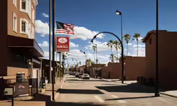 a street with buildings and several palm trees