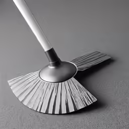 a close up of a broom with a metal handle