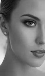 a beautiful woman with a messy updo with earrings on
