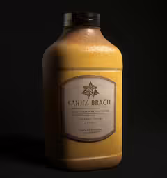 a yellow can - o - bach bottle on a black background
