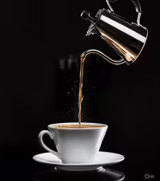 the image shows a cup with coffee spilling from it