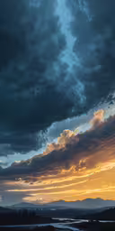 a cloudy sky with mountains and water in the background,the sky is a blazing yellow light through clouds