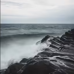 some very pretty waves crashing against some rocks