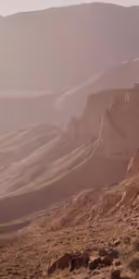 an empty valley with mountains in the background