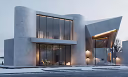 an architecturally designed house has been lit up in the evening