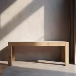 an empty bench against a white wall and floor