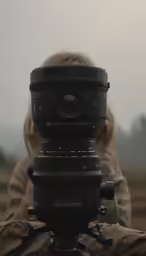a woman with camera in front of her face