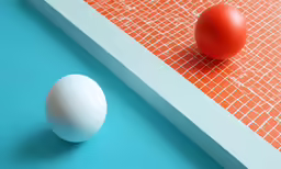 an egg and an orange ball next to each other