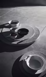 this table has bowls on it and plates in the middle