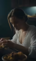 a woman with a white shirt on is holding something in her hands