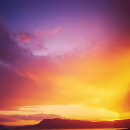 the sun is setting behind the clouds and on the water