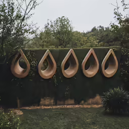 some art piece on a wall with trees and grass