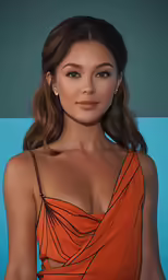 a woman in an orange dress poses for the camera