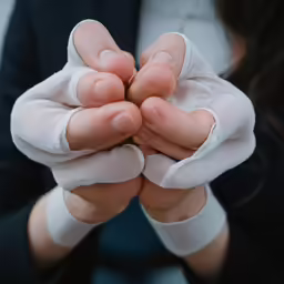 person holding both hands together to show the signs