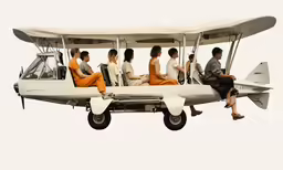 people are sitting on the wing of an airplane