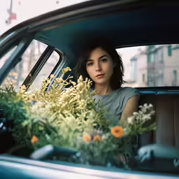 a woman is sitting in the back seat of a car