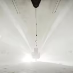 a car hangs in the fog under a beam