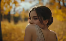 a beautiful woman in an elegant dress is posing for the camera