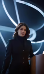 a woman standing behind a lecterine and lighting