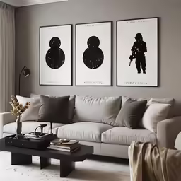 three paintings are hung above a white sofa