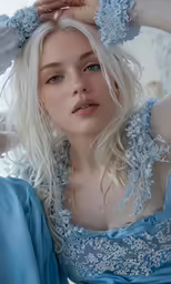 a woman wearing a blue gown and posing