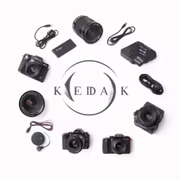 various cameras and some headphones on a white surface