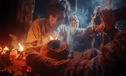 a man lighting a candle on a string